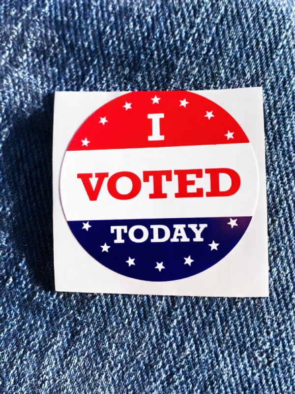 An I Voted Today sticker on blue denim.